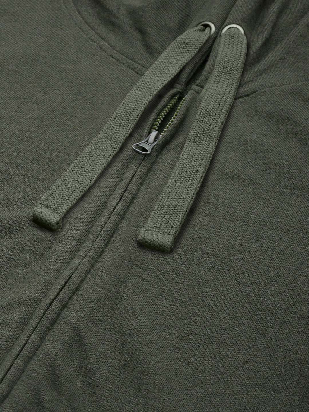 Close-up of an olive green zip-up hoodie showing the front zipper, drawstrings, and textured fabric.