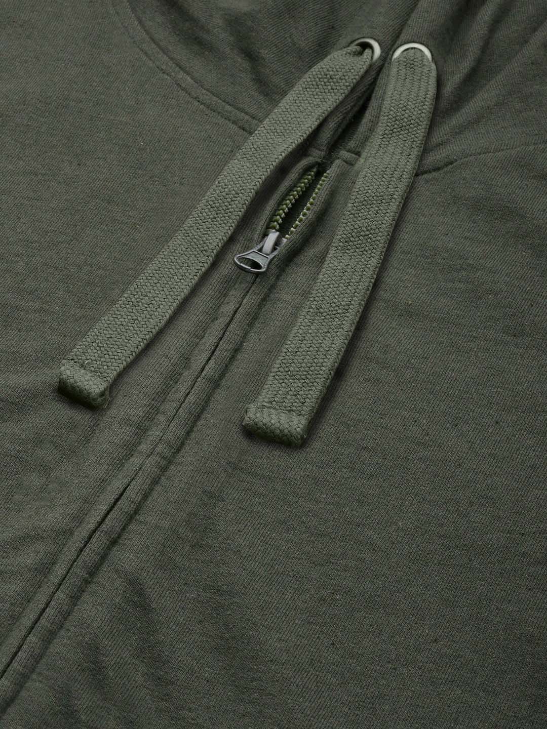 Close-up of an olive green zip-up hoodie showing the front zipper, drawstrings, and textured fabric.