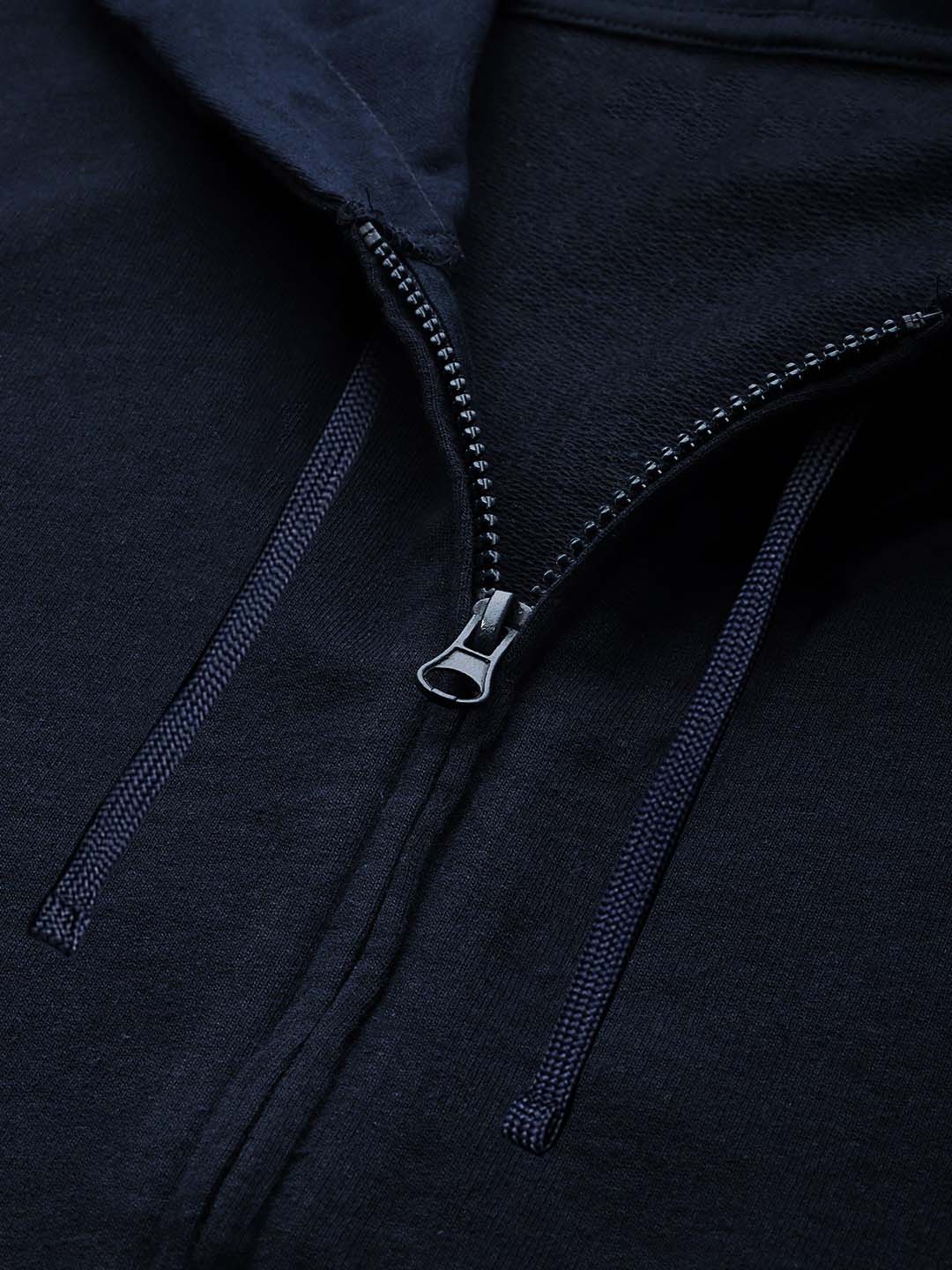 Close-up of a dark navy zip-up hoodie showing the front zipper, drawstrings, and fabric texture.